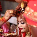 An Indian wedding ceremony, the groom applying sindoor