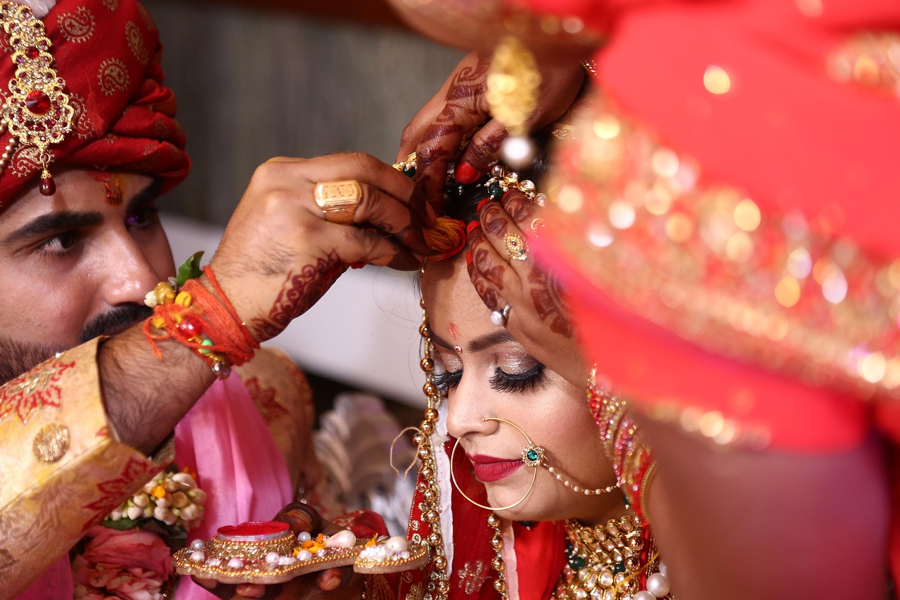 An Indian wedding ceremony, the groom applying sindoor